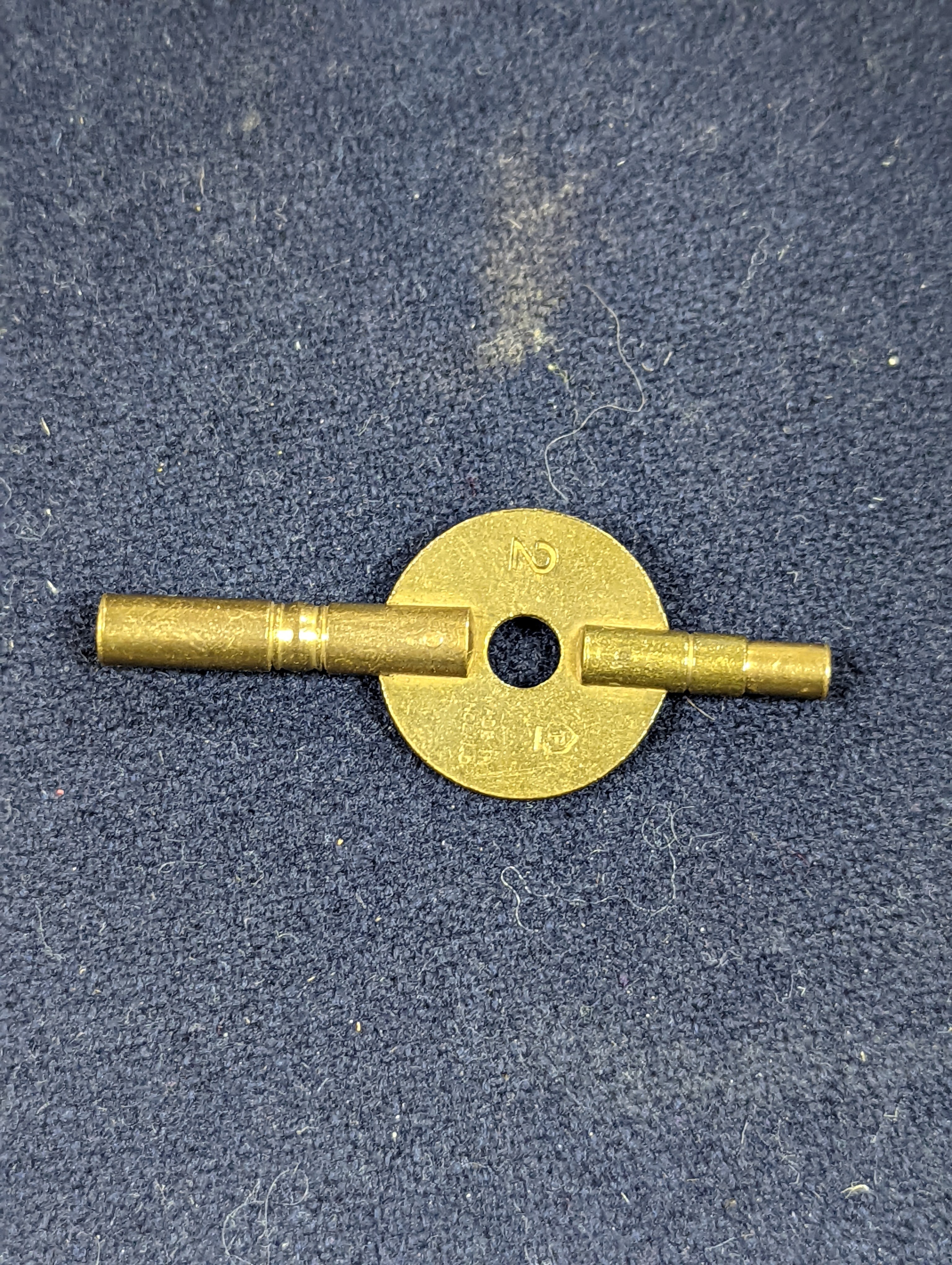 A Henri Jacot brass miniature carriage timepiece, 9.7 cm high with the handle up, cased